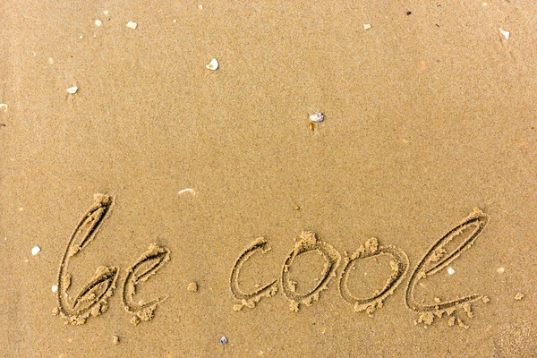 Be cool written on the beach sand