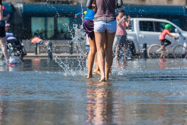 People having fun in a mirror fountain