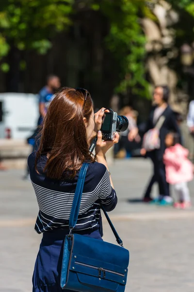 Young woman taking a photo