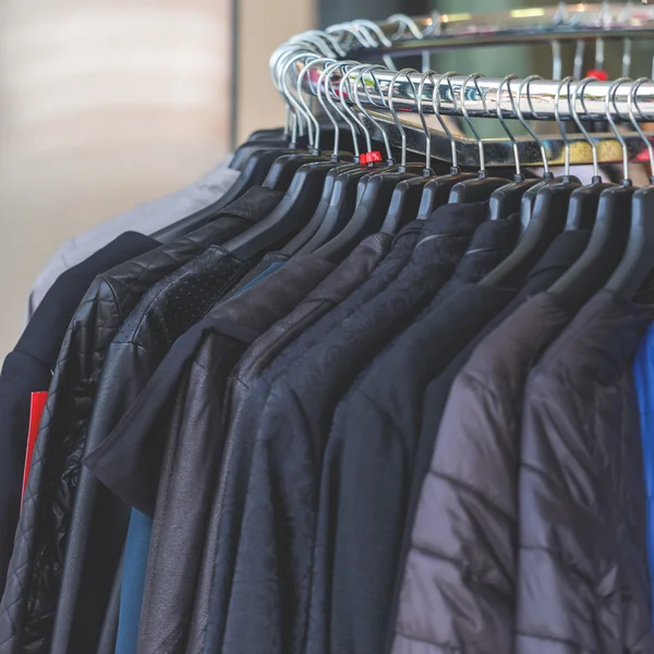 Dark autumn clothes hanging at a store