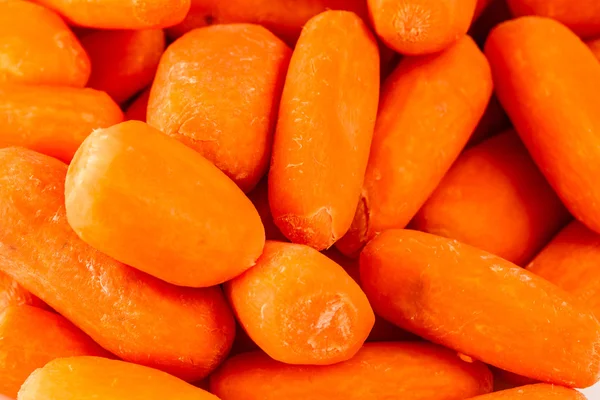 Top view of a group of organic small baby carrots isolated on a white background
