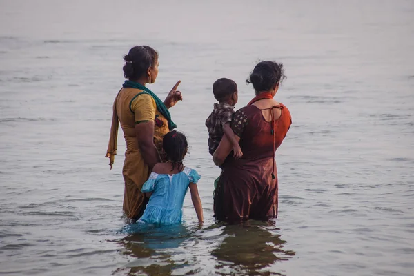 VARKALA, KERALA, INDIA - DECEMBER 15 , 2012: Unidentified Hindu family do holy bathe at the sacred confluence on  Papanasam beach
