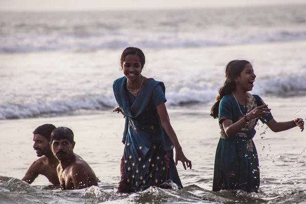 VARKALA, KERALA, INDIA - DECEMBER 15 , 2012: Unidentified Hindu family do holy bathe at the sacred confluence on  Papanasam beach