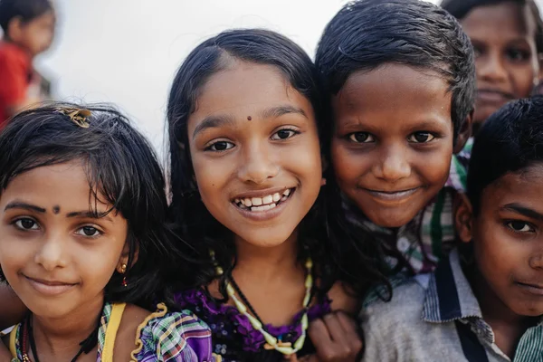 VARKALA, KERALA, INDIA - DECEMBER 15, 2012:  Portrait smiling indian children on Varkala during puja ceremony on holy place - on the Papanasam beach