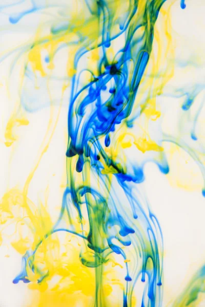 Blue and yellow liquid in water