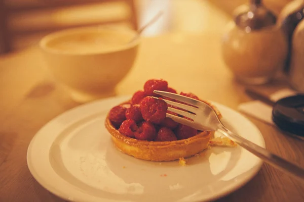 Sweet basket with cream and raspberries