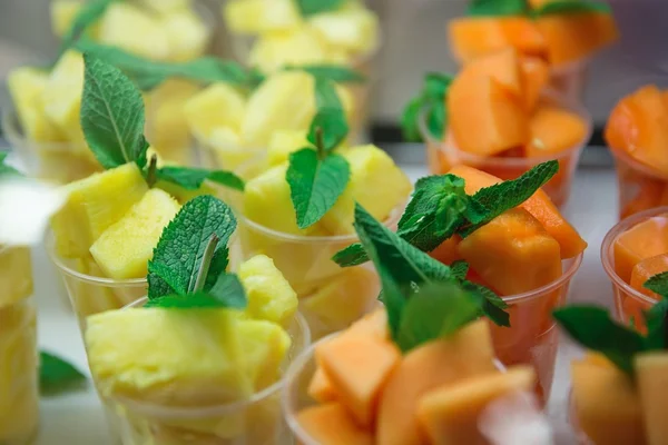 Pineapple and melon with mint leaves