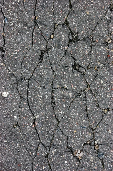 Old aged weathered cracked tarmac texture, large detailed damaged textured asphalt grungy background, vertical grey, black rough grained, broken pattern macro closeup detail grunge copy space