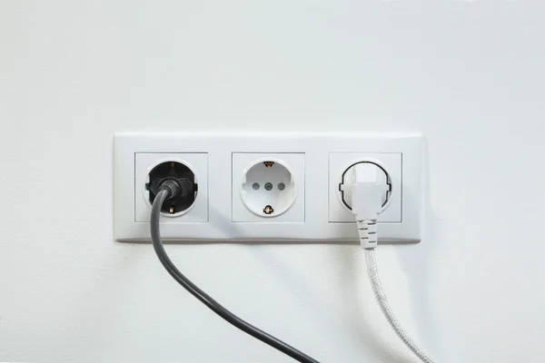 Power plugs plugged in a electric socket