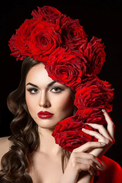 Beautiful Fashion Model Girl Portrait with big Red Roses in hair
