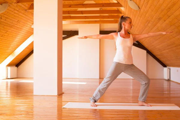 Woman practicing Yoga in a Studio