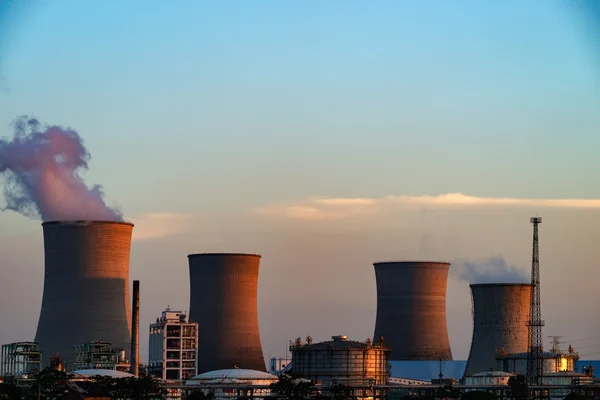 The smokestacks of coal-fired power plants in the blue sky background