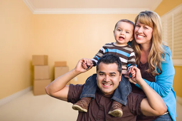 Young Mixed Race Family In Room With Moving Boxes