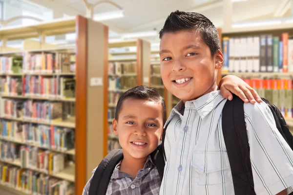 Young Hispanic Student Brothers In Library