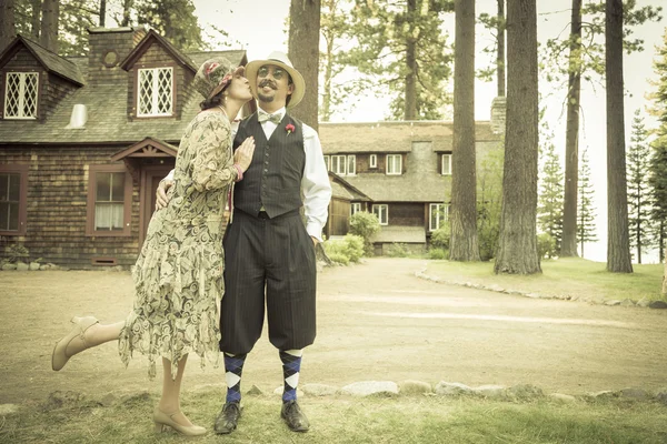 1920s Dressed Romantic Couple in Front of Old Cabin