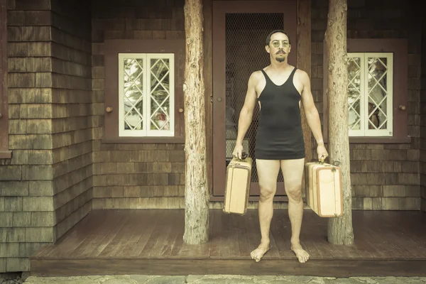 Gentleman Dressed in 1920s Era Swimsuit Holding Suitcases on