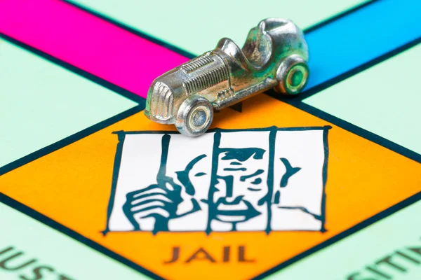 Car token next to the JAIL in a Monopoly game