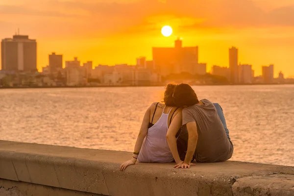 Couple looking at a sunset in Havana