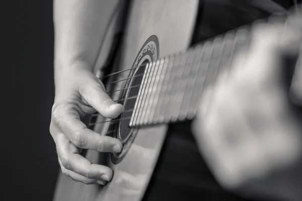 Hands playing a classic guitar