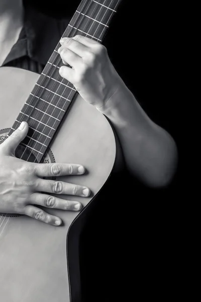 Musician's hands playing guitar