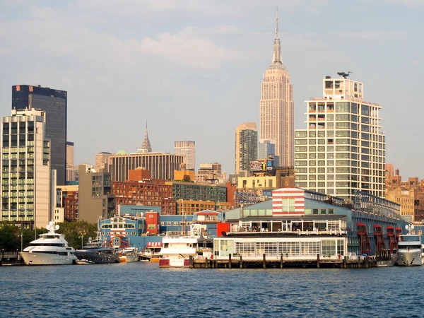 Piers and boats along Manhattan with the Empire State Building o