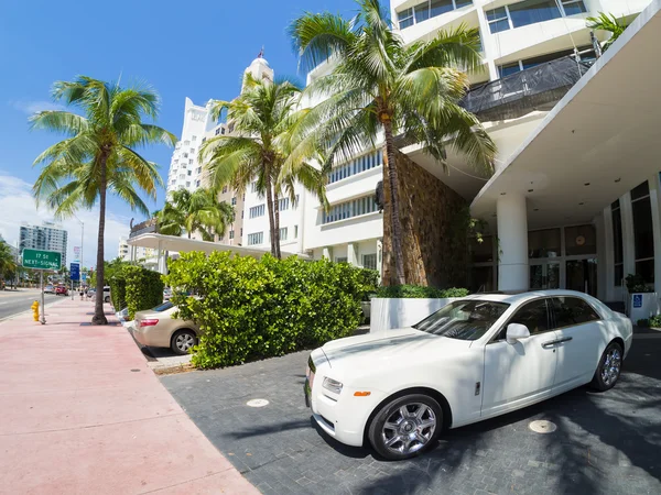 Rolls Royce luxury car next to a famous hotel at Miami Beach