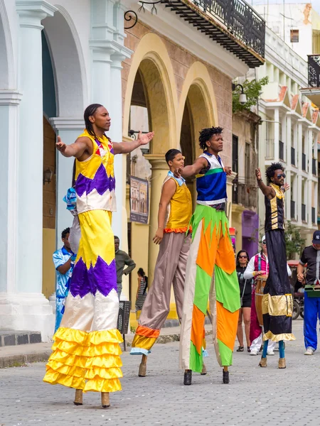 Street performers dancing on stilts in Old Havana