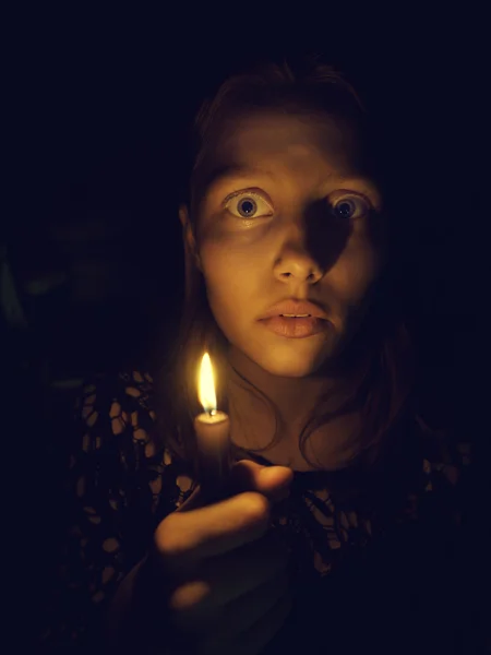 Teen girl with a candle