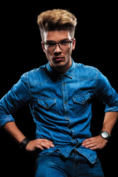 Male model posing wearing jeans, denim shirt and glasses