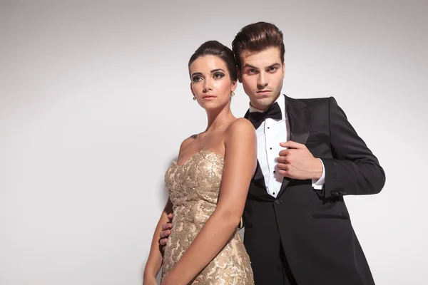 Elegant fashion couple posing on grey studio background