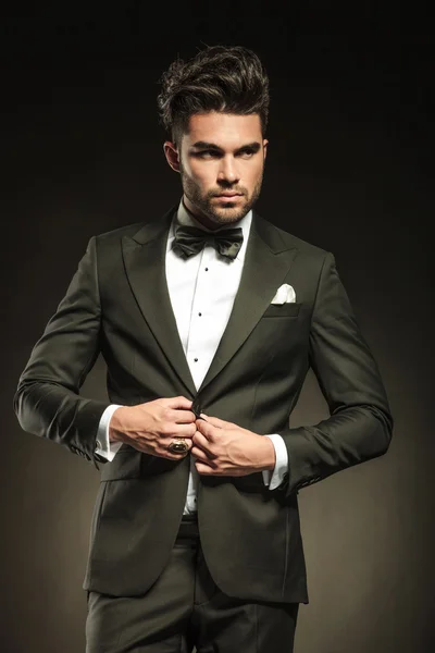 Elegant business man arranging his tuxedo