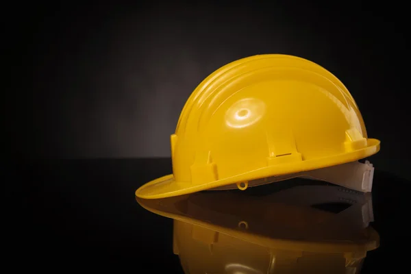 Side view of a yellow construction safety helmet