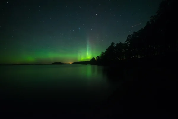 Northern lights over calm lake