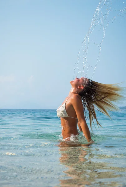 Woman  in the water waving hair