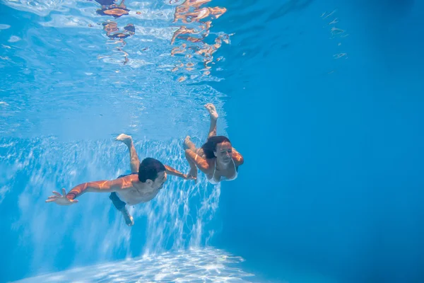 Underwater couple  in the swimming pool.