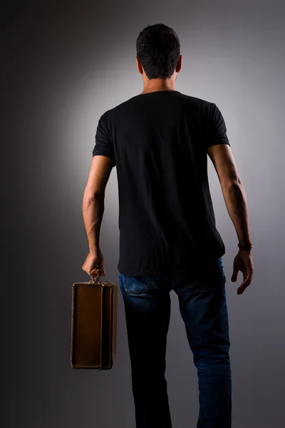 Ortrait of stylish confident man with vintage suitcase