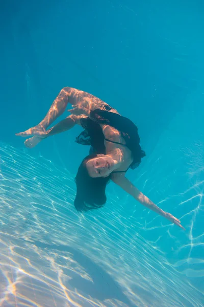 Young woman swimming undewater