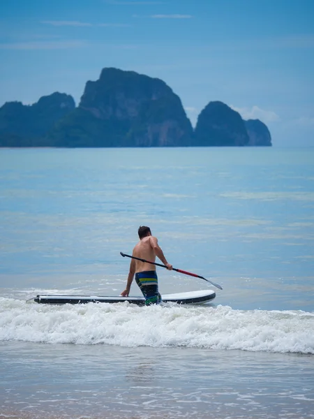 Man Stand up paddle surfing in Thailand