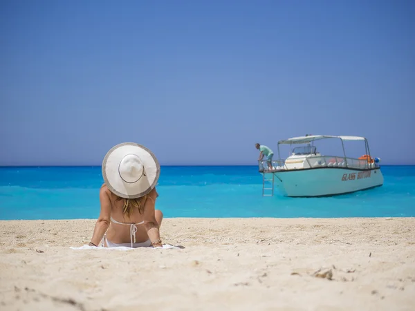 Woman relaxing on the famous Shipwreck beach in Zakynthos