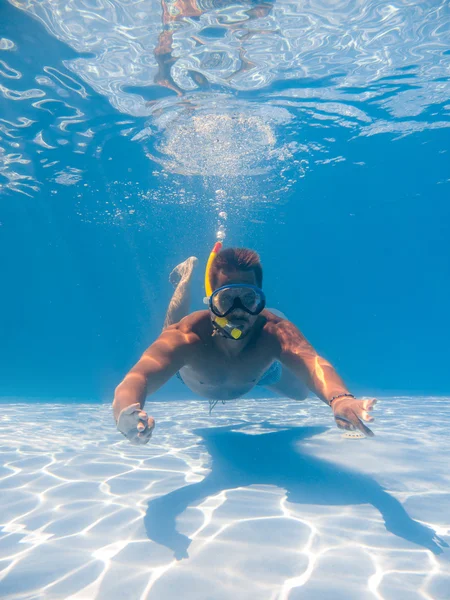 Man wearing snorkel underwater