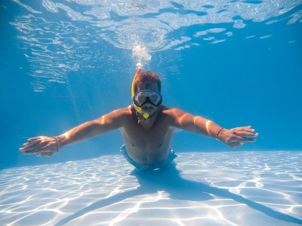 Man wearing snorkel underwater