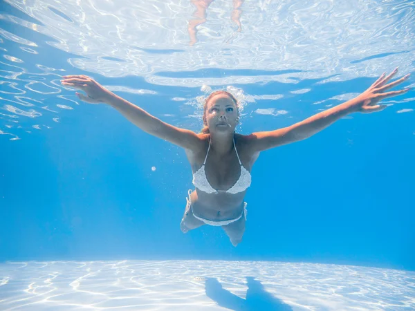 Young woman swimming underwater