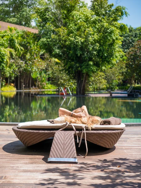 girl resting by the swimming pool