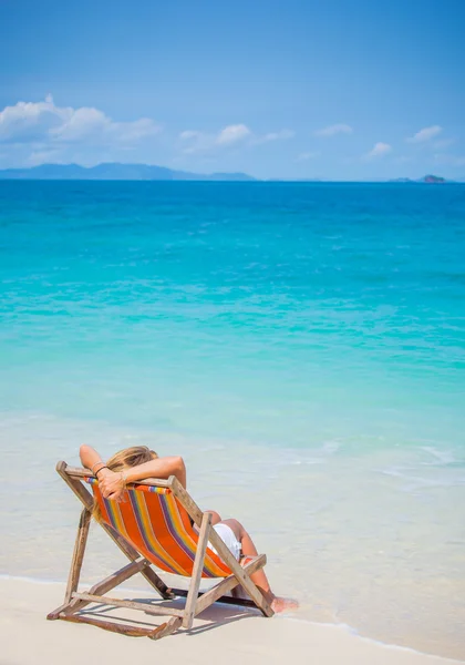 Woman relaxing on deck chair