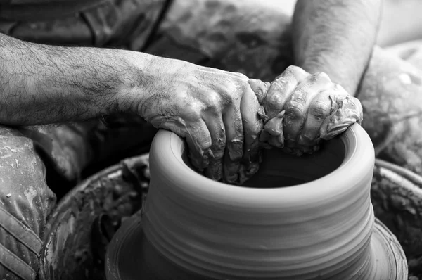 Craftsman making vase on pottery wheel