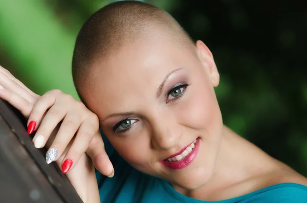 Beautiful young bald woman - cancer survivor