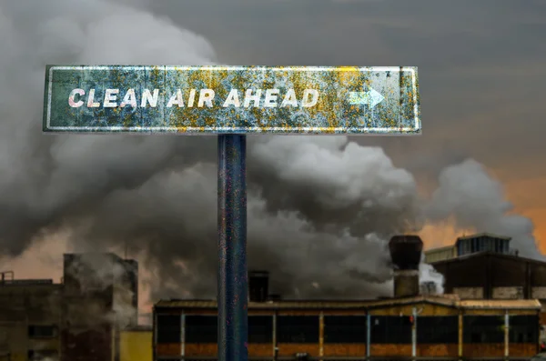 Clean air ahead slogan on the road sign in front of the pollutin