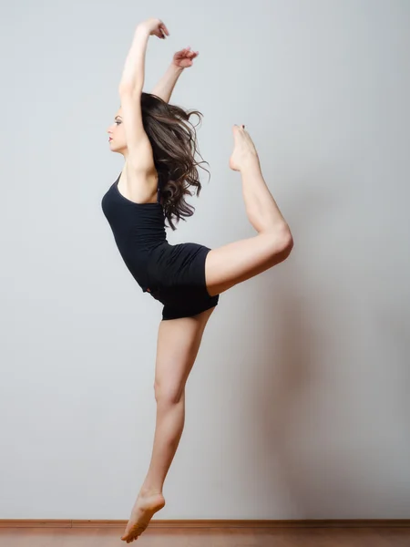 Young ballet dancer jumping high in the air