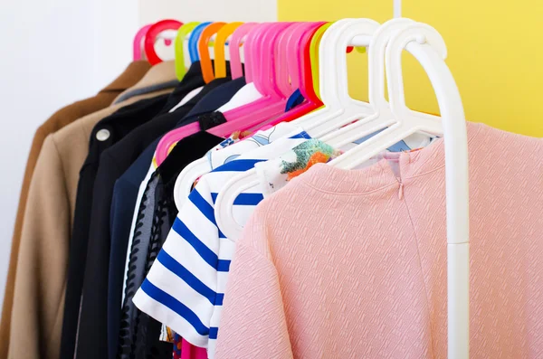 Various second hand woman clothes on the hanger in boutique