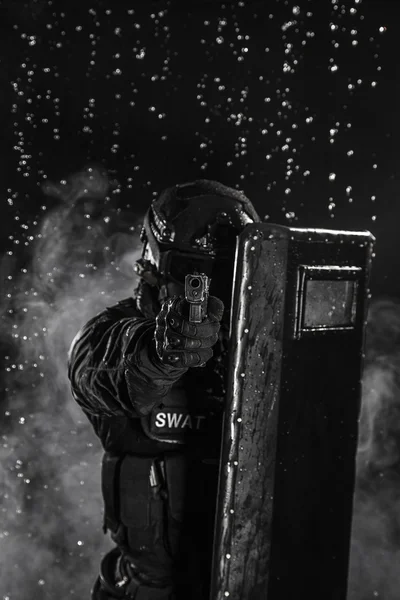 Police officer with ballistic shield